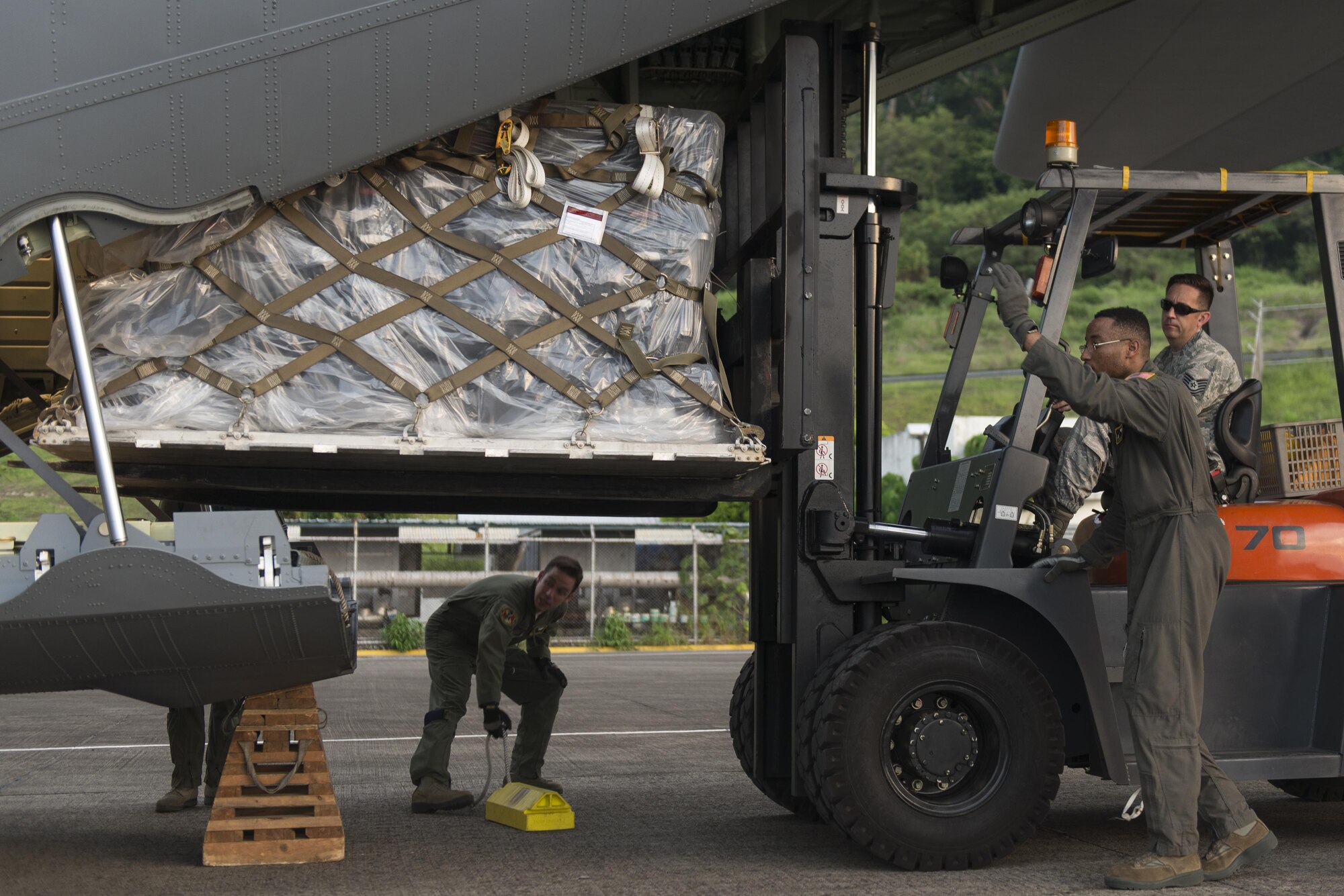 Airman 1st Class Young Achuka, 36th Airlift Squadron C-130J loadmaster, guides Tech. Sgt. Phillip Eyer, 374th Logistics and Readiness Squadron joint inspector, while loading cargo on to a C-130J Super Hercules assigned to Yokota Air Base, Japan, during its first C-130J operational mission, June 30, 2017, at Manila, Philippines. The mission gave the Airmen the chance to showcase the aircraft’s airlift capabilities. (U.S. Air Force photo by Airman 1st Class Juan Torres)