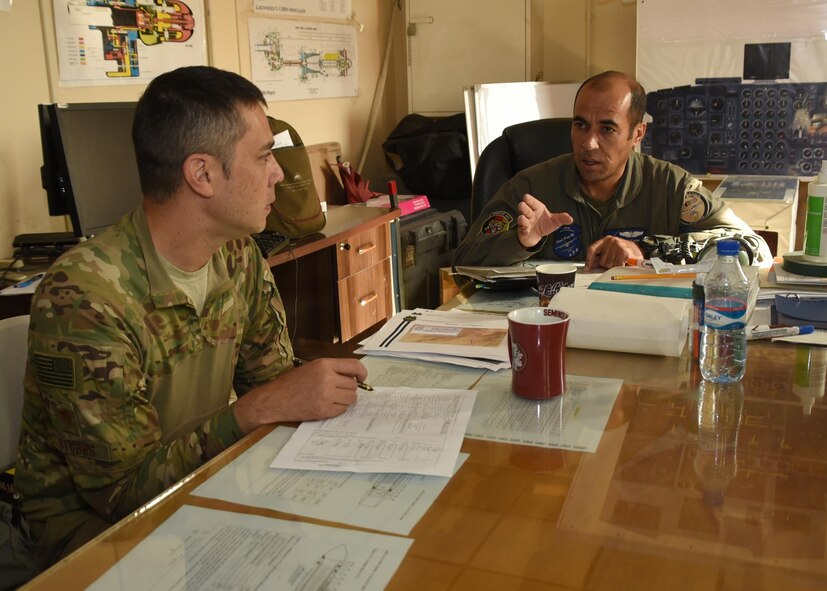 An Afghan air force C-208 pilot, conducts a preflight briefing in preparation of an airdrop mission with Maj. Randy Stubbs, Train, Advise, Assist Command-Air, 538th Air Expeditionary Advisory Squadron C-208 pilot advisor, June 28, 2017, at Kabul Air Wing, Afghanistan. This was the first operational airdrop performed by AAF aircrew. The AAF successfully delivered 800 pounds of supplies to Afghan Border Police at their coordinated drop zone. (U.S. Air Force photo by Tech. Sgt. Veronica Pierce)