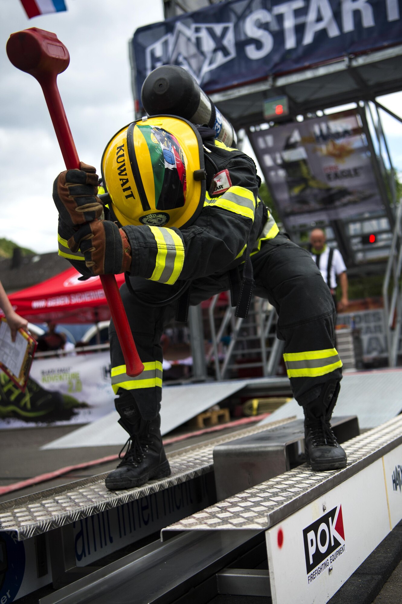 A firefighter from Kuwait uses a Kaiser Force Machine while racing against an opponent during the 4th annual Mosel Firefighter Combat Challenge in Ediger-Eller, Germany, June 30, 2017. The Kaiser Force Machine was the third obstacle of the timed competition and simulates the opening of a roof or a forcible entry to ventilate smoke and heat. (U.S. Air Force photo by Senior Airman Preston Cherry)
