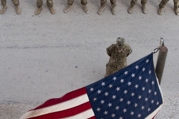 Capt. Jared Goss, 332nd Expeditionary Security Forces Squadron operations officer, leads a formation of Airmen during a retreat ceremony June 30, 2017, in Southwest Asia. The ceremony was held to honor and remember service members who have made the ultimate sacrifice. (U.S. Air Force photo/Senior Airman Damon Kasberg)