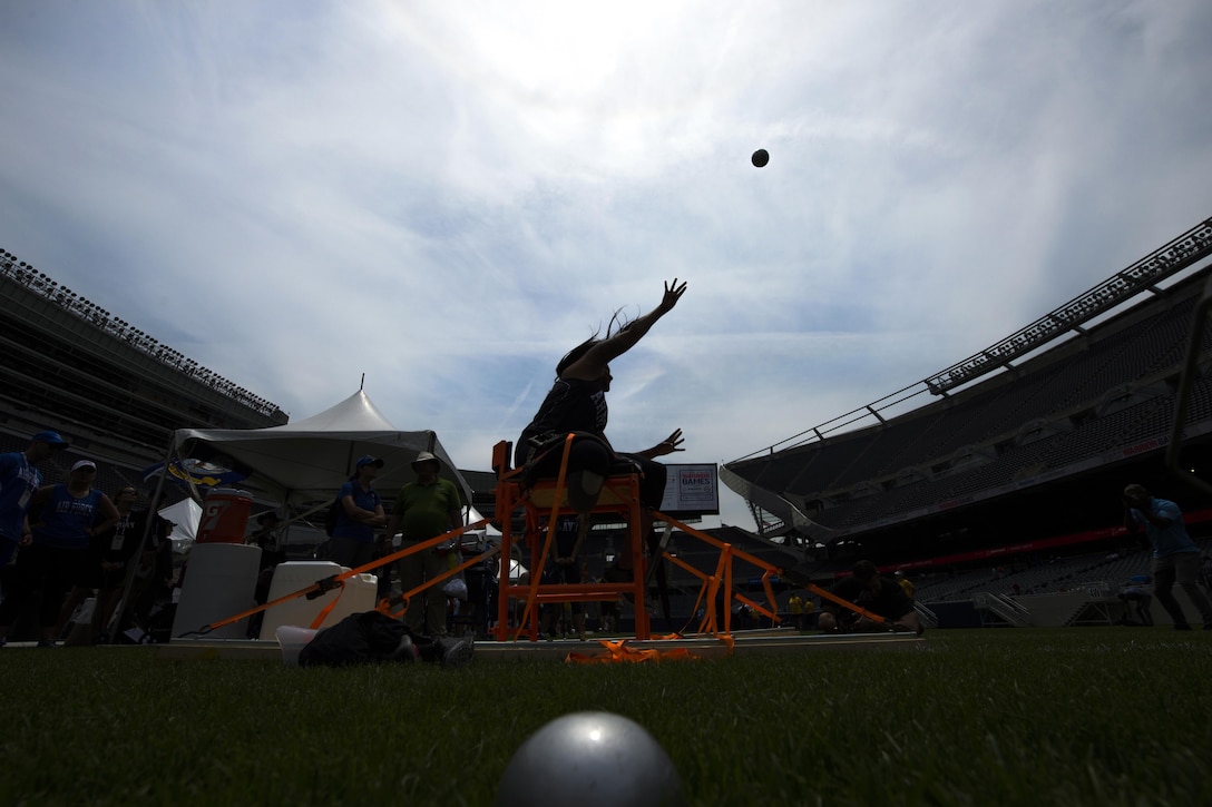 A bright sky silhouettes an athlete competing in seated shot put at Soldier Field for the 2017 Department of Defense Warrior Games in Chicago, July 5, 2017. The Warrior Games are an annual event allowing wounded, ill and injured service members and veterans to compete in Paralympic-style sports. DoD photo by EJ Hersom