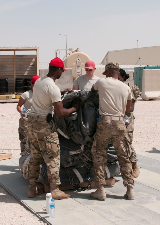 Soldiers of the 824th Quartermaster Company stack parachutes used for aerial delivery at Al Udeid Air Base, Qatar on April 19, 2017. Aerial delivery operations are essential for getting supplies to troops in the Middle East when conventional means of transportation are not feasible. (U.S. Army photo by Sgt. Jeremy Bratt)