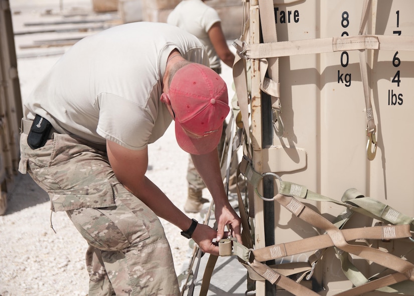 Sgt. Brandon Krieger, of the 824th Quartermaster Company, secures a container with cargo netting for aerial delivery at Al Udeid Air Base, Qatar on April 19, 2017. Aerial delivery operations are essential for getting supplies to troops in the Middle East when conventional means of transportation are not feasible. (U.S. Army photo by Sgt. Jeremy Bratt)