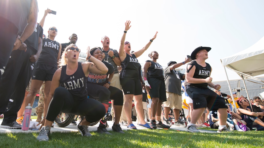 Team Army members react as Army Sgt. David Crook, not pictured, throws a discus into the stands during the 2017 Department of Defense Warrior Games in Chicago, July 3, 2017. DoD photo by Roger L. Wollenberg 