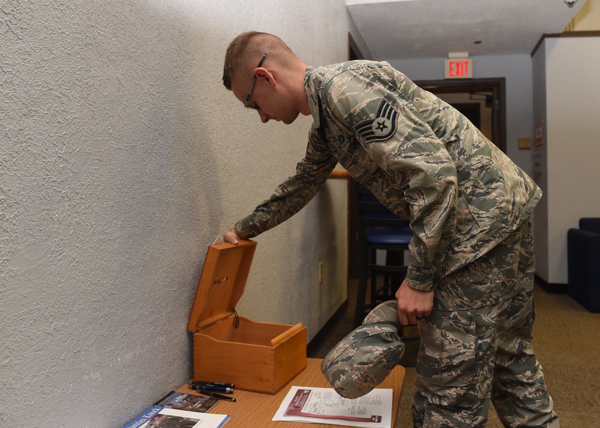 U.S. Air Force Staff Sgt. William Harrison, 97th Civil Engineer Squadron Airmen dorm leader, checks for workorders in the dayroom of dormitory 333, June 29, 2017, at Altus Air Force Base, Oklahoma. Dorm management works to improve dorm quality of life for the first-term Airmen living on base by preforming multiple tasks to maintain the longevity of the Altus AFB dorms. (U.S. Air Force Photo by Airman 1st Class Jackson N. Haddon/Released).