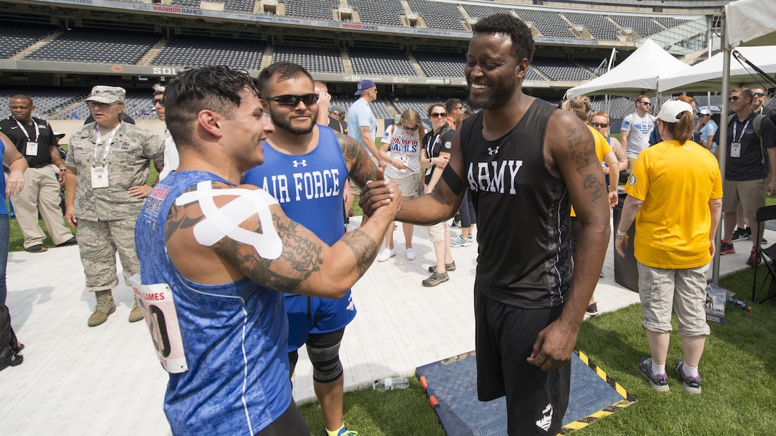 Air Force Staff Sgt. Vincent Cavazos, Air Force Senior Airman Rafael Morfinenciso and Army veteran Staff Sgt. Charles Hightower, right, congratulate each other after the shot put competition during the 2017 Department of Defense Warrior Games in Chicago, July 3, 2017. They won gold, bronze and silver respectively. DoD photo by Roger L. Wollenberg