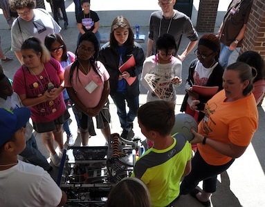 KING GEORGE. Va. (June 28, 2017) - Naval Surface Warfare Center Dahlgren Division (NSWCDD) computer engineer Cassandra Robison, right, briefs science, technology, engineering, and mathematics (STEM) Summer Academy "campers" on the computer programming and technology behind the Kilroy 339 robot as well as its capabilities and operation. Robison was among 17 Navy science and engineer mentors inspiring the students - many who may one day be STEM mentors themselves - throughout the week-long 2017 NSWCDD-sponsored STEM Summer Academy.