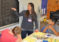 KING GEORGE, Va. (June 28, 2017) - Kerrie Pierce, a King George Middle School life science teacher, reviews the number of each M&M color her students predict will be found in a large bag after compiling statistics on the numbers in smaller bags. The middle school students used M&Ms to learn about statistics and measurement at the 2017 Naval Surface Warfare Center Dahlgren Division (NSWCDD)-sponsored Navy science, technology, engineering, and mathematics (STEM) Summer Academy, held June 26-30. Camp activities also included ten robotic challenges; building a water rocket and determining the optimal fuel loading to maximize height; exploring epidemiology; building and destructively testing a tower from balsa wood with the goal of maximizing the strength to weight ratio; and building a boat out of foil and straws with the aim of maximizing its cargo carrying capacity.