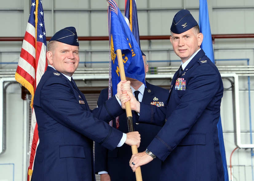 U.S. Air Force Col. Thomas D. Torkelson, left, 100th Air Refueling Wing commander, passes the guidon to U.S. Air Force Col. Matthew Pollock, 100th Maintenance Group commander, July 6, 2017, during a change of command ceremony on RAF Mildenhall, England. The ceremony is a time-honored tradition in which one officer relinquishes command and passes it to another. (U.S. Air Force photo by Karen Abeyasekere)