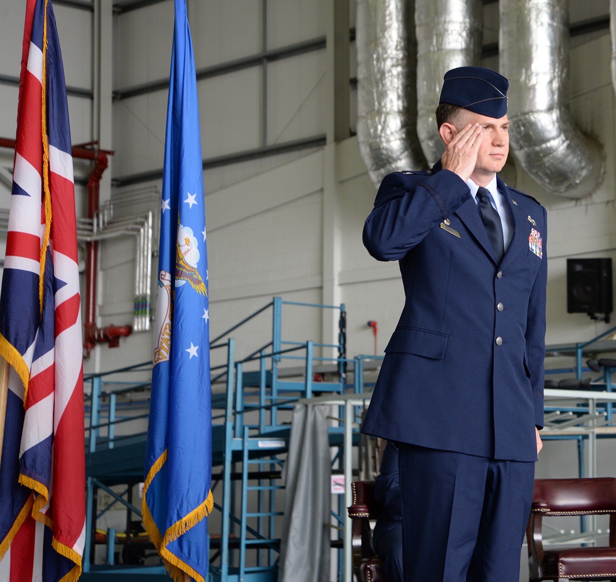 U.S. Air Force Col. Matthew Pollock, 100th Maintenance Group commander, gives his first salute to Airmen at the 100th MXG change of command ceremony July 6, 2017, on RAF Mildenhall, England. Pollock was previously the chief of V-22 Joint Readiness, PMA-275, Patuxent River Naval Air Station, Md. (U.S. Air Force photo by Karen Abeyasekere)
