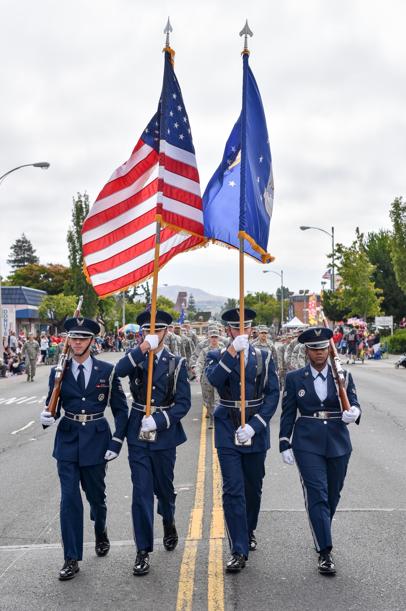Members of the Travis Air Force Base Honor Guard march along Tennessee St. in Vallejo, Calif., during the city’s annual Independence Day Parade, July 4, 2017. About 75 Airmen from the 60th Medical Group and 821st Contingency Response Squadron also participated in the parade, with residents cheering them along a 1.5-mile path through the city. (U.S. Air Force photo by Ken Wright)