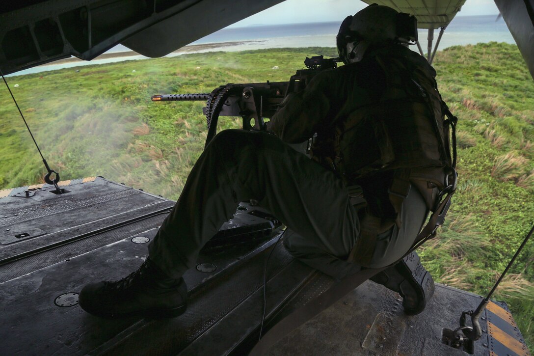 Marine Corps Sgt. Cole Bennick fires a M2 .50 caliber machine gun from the tail ramp of a CH-53E Super Stallion helicopter during aerial gunnery training over Okinawa, Japan, June 27, 2017. Bennick is a crew chief assigned to Heavy Helicopter Squadron 462, 3rd Marine Aircraft Wing, 1st Marine Aircraft Wing. Marine Corps photo by Sgt. Rebecca L. Floto