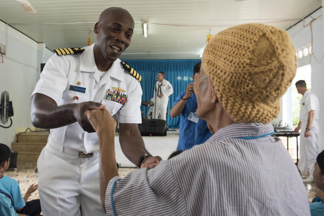 Navy Capt. Lex Walker, commodore, Destroyer Squadron 7, dances with a resident of Khanh Hoa Center for Social Protection during a performance by the U.S. 7th Fleet Band’s Orient Express as a part of Naval Engagement Activity Vietnam 2017 in Nha Trang, Vietnam, July 6, 2017. Navy photo by Petty Officer 2nd Class Joshua Fulton