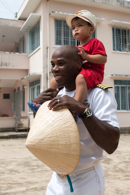 Navy Capt. Lex Walker, commodore, Destroyer Squadron 7, interacts with a resident of the Khanh Hoa Center for Social Protection during Naval Engagement Activity Vietnam 2017 in Nha Trang, Vietnam, July 6, 2017. Navy photo by Petty Officer 2nd Class Joshua Fulton