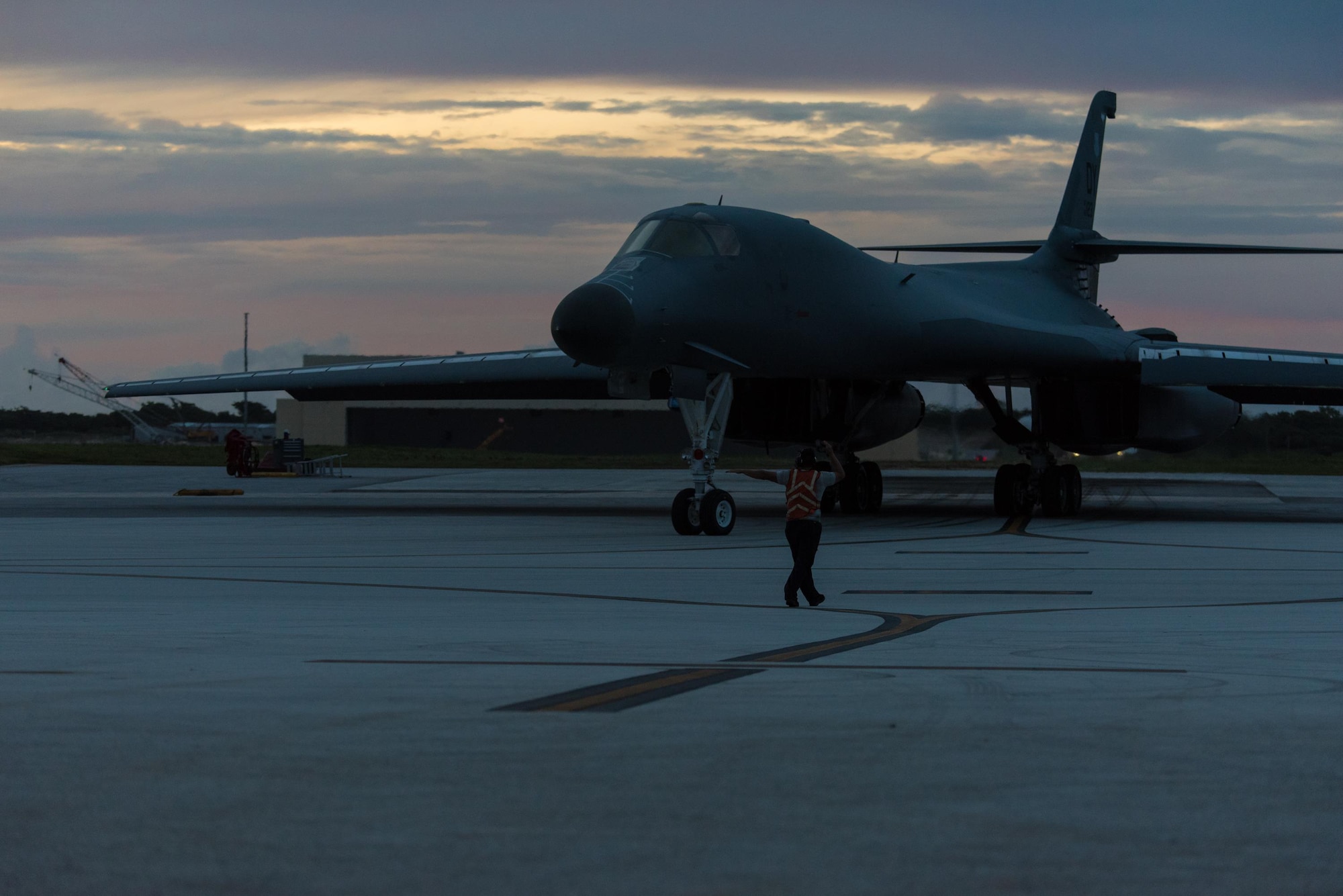 A U.S. Air Force B-1B Lancer assigned to the 9th Expeditionary Bomb Squadron, deployed from Dyess Air Force Base, Texas, is marshaled onto the runway as it prepares to take off from Andersen Air Force Base, Guam, to fly a bilateral mission with two Japan Air Self-Defense Force F-15’s over the East China Sea, July 6, 2017. Bilateral training fosters increased interoperability between Japan and U.S. aircraft. Participating in bilateral training enables the operational units to improve their combined capabilities and tactical skills, while also building bilateral confidence and strong working relationships. (U.S. Air Force photo by Airman 1st Class Jacob Skovo)