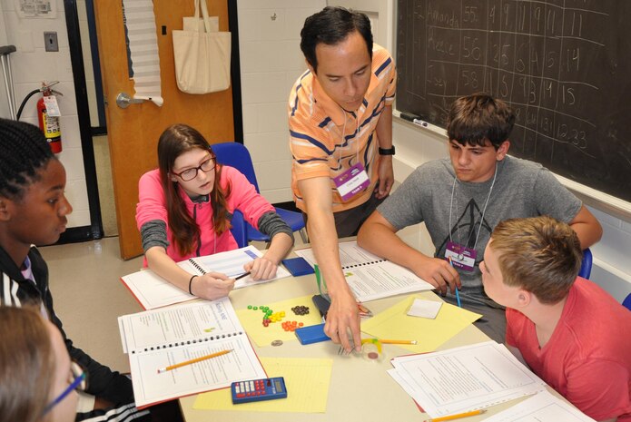 KING GEORGE, Va. (June 28, 2017) - Cesar Smith, a Navy systems engineer, explains a logistics challenge to middle school students at the 2017 Naval Surface Warfare Center Dahlgren Division sponsored Navy STEM (science, technology, engineering, and mathematics) Summer Academy. "They had to come up with a plan on how to rescue the gummy worm using only the tools and materials provided to them," said Smith. "It gets the students thinking about their strategy for completing the mission, step by step - and putting their plan on paper - before attempting a trial and error approach." 