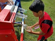 KING GEORGE. Va. (June 29, 2017) - A middle school student prepares his water rocket for launch at the 2017 Naval Surface Warfare Center Dahlgren Division sponsored STEM Summer Academy, held June 26-30. Camp activities also included ten robotic challenges; exploring epidemiology; building and destructively testing a tower from balsa wood with the goal of maximizing the strength to weight ratio; predicting the number of each color of M&Ms in a large bag after compiling statistics on numbers in smaller bags; and building a boat out of foil and straws with the aim of maximizing its cargo carrying capacity.