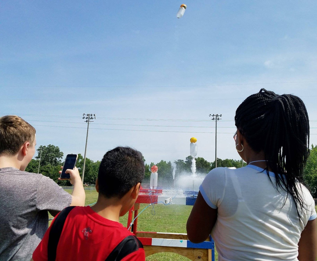 KING GEORGE. Va. (June 29, 2017) - Middle school students fire water rockets they built with fuel load to maximize height at the 2017 Naval Surface Warfare Center Dahlgren Division sponsored STEM Summer Academy, held June 26-30. Camp activities also included ten robotic challenges; exploring epidemiology; building and destructively testing a tower from balsa wood with the goal of maximizing the strength to weight ratio; predicting the number of each color of M&Ms in a large bag after compiling statistics on numbers in smaller bags; and building a boat out of foil and straws with the aim of maximizing its cargo carrying capacity.