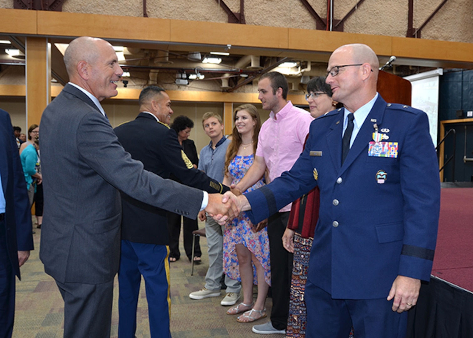 Outgoing Commander Air Force Brig. Gen. Allan Day shakes hands with Defense Logistics Agency Aviation Deputy Commander Charles Lilli in a receiving line after the DLA Aviation change of command ceremony June 28, 2017 on Defense Supply Center Richmond, Virginia. 