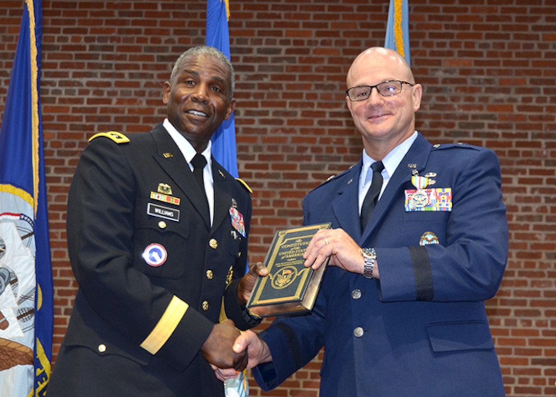 Defense Logistics Agency Director Army Lt. Gen. Darrell Williams presents outgoing DLA Aviation Commander Air Force Brig. Gen. Allan Day with a personal copy of the U.S. Constitution June 28, 2017 during a change of command ceremony on Defense Supply Center Richmond, Virginia.  