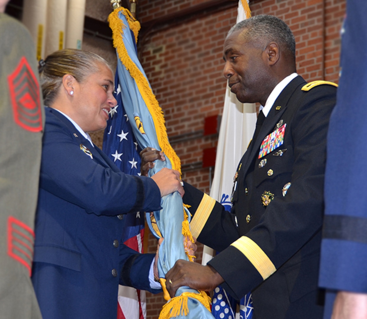 Defense Logistics Agency Director Army Lt. Gen. Darrell Williams passes the DLA flag to Air Force Brig. Gen. Linda Hurry as she assumes command of DLA Aviation June 28, 2017 during a ceremony on Defense Supply Center Richmond, Virginia.  