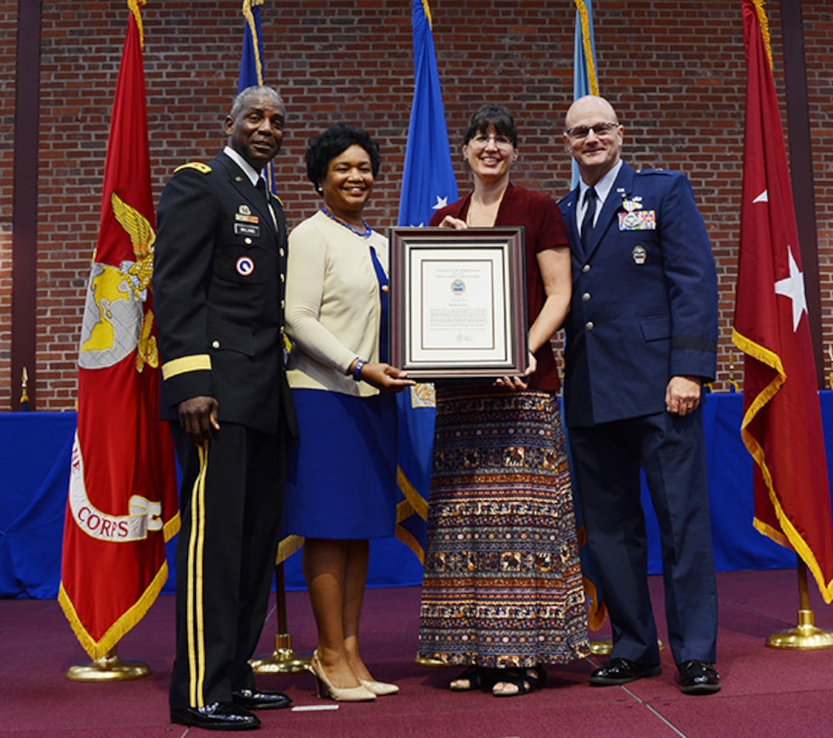 Defense Logistics Agency Director Army Lt. Gen. Darrell Williams, from left, and his wife Myra present Barbara Day with a spouse’s certificate of appreciation for her commitment to supporting her husband, Air Force Brig. Gen. Allan Day and the DLA Aviation family during his change of command ceremony June 28, 2017 on Defense Supply Center Richmond, Virginia.