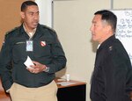 Col. Manuel Carrasco, Dominican Republic Army (left) speaks with Maj. Gen. K.K. Chinn, U.S. Army South commander, during a mock natural disaster training exercise June 21 at the Conference of American Armies, or CAA, event in Santiago, Chile. 