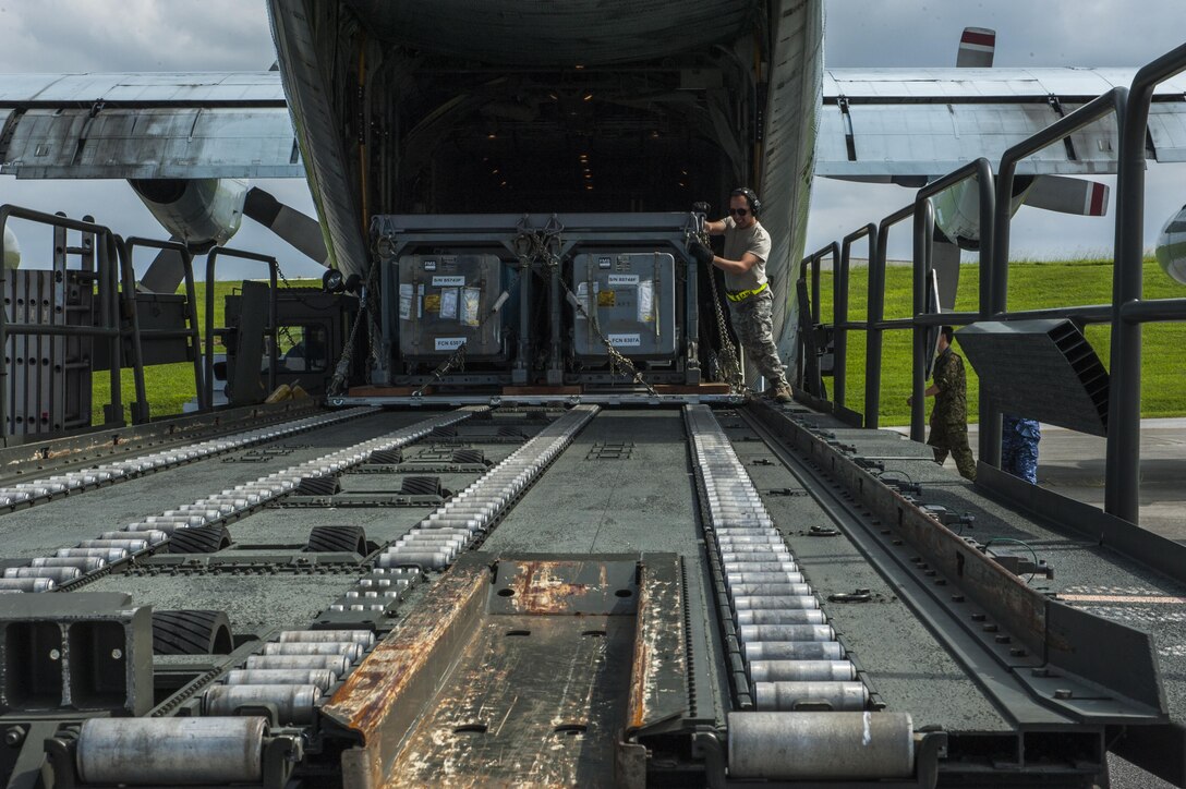 U.S. Air Force Airman 1st Class Ivan Tamez, 733rd Air Mobility Squadron aircraft services specialist, unloads a Japanese Air Self Defense Force C-130 Globemaster taking part in Exercise Keen Sword Oct. 30, 2016, on the flightline at Kadena Air Base, Japan. Keen Sword is a multi-phase exercise which involves multiple bases and branches from across the Pacific theater. (U.S. Air Force photo by Airman 1st Class Nick Emerick /Released) 
