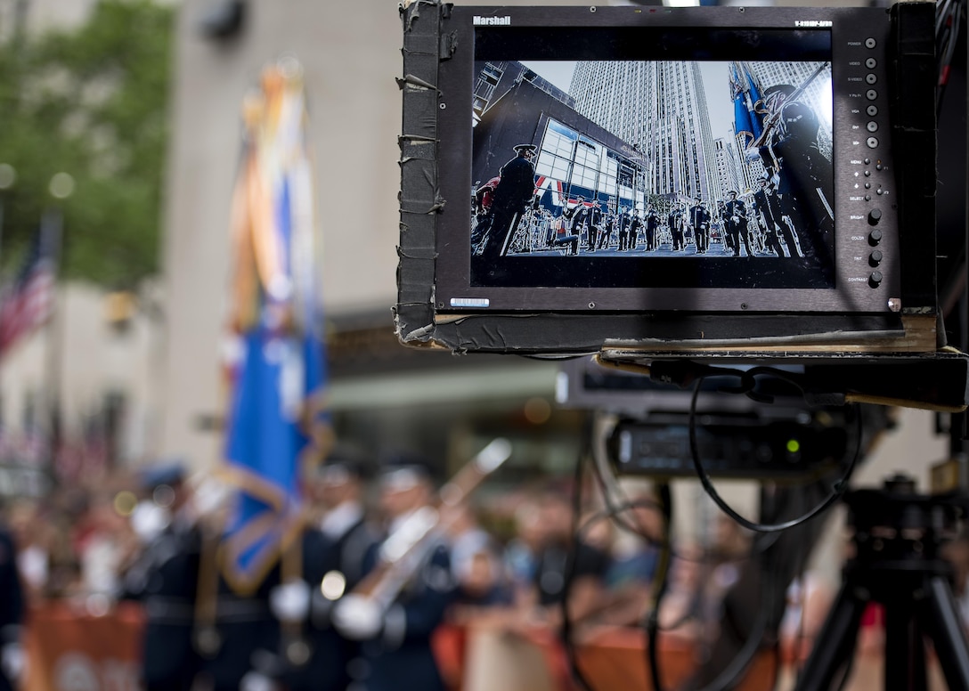 The U.S. Air Force Band ceremonial brass ensemble and Honor Guard color team appear on a camera screen during a Today Show taping near Rockefeller Plaza in New York City, July 4, 2017. They were there to represent the men and women of the U.S. Air Force during Independence Day celebrations in New York. Following the Today Show taping, they performed during the opening ceremonies at Yankee Stadium for a Yankees baseball game. (US Air Force Photo by Airman 1st Class Gabrielle Spalding)