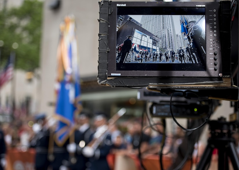 The U.S. Air Force Band ceremonial brass ensemble and Honor Guard color team appear on a camera screen during a Today Show taping near Rockefeller Plaza in New York City, July 4, 2017. They were there to represent the men and women of the U.S. Air Force during Independence Day celebrations in New York. Following the Today Show taping, they performed during the opening ceremonies at Yankee Stadium for a Yankees baseball game. (US Air Force Photo by Airman 1st Class Gabrielle Spalding)