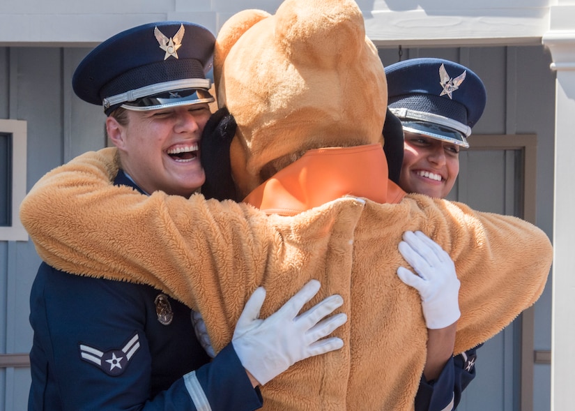 Airman 1st Class Alyssa VanGorder, left, and Airman Daniella Bejarano, right, U.S. Air Force Honor Guard ceremonial guardsmen, hug the Disney character Goofy at Disneyland in Anaheim, Calif., June 29, 2017. In order to perform across the country with collective accuracy, the team practiced the routine approximately six times together before leaving Joint Base Anacostia-Bolling, District of Columbia, and prior to the start of each performance day on the trip. (U.S. Air Force photo by Senior Airman Jordyn Fetter)
