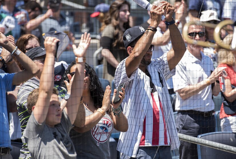 Audience members applaud after the playing of the national anthem at Yankee Stadium in New York City, July 4, 2017. The U.S. Air Force Band ceremonial brass quintet and an Honor Guard color team were there to represent the men and women of the U.S. Air Force during the opening ceremonies at a Yankees baseball game. (US Air Force Photo by Airman 1st Class Gabrielle Spalding)