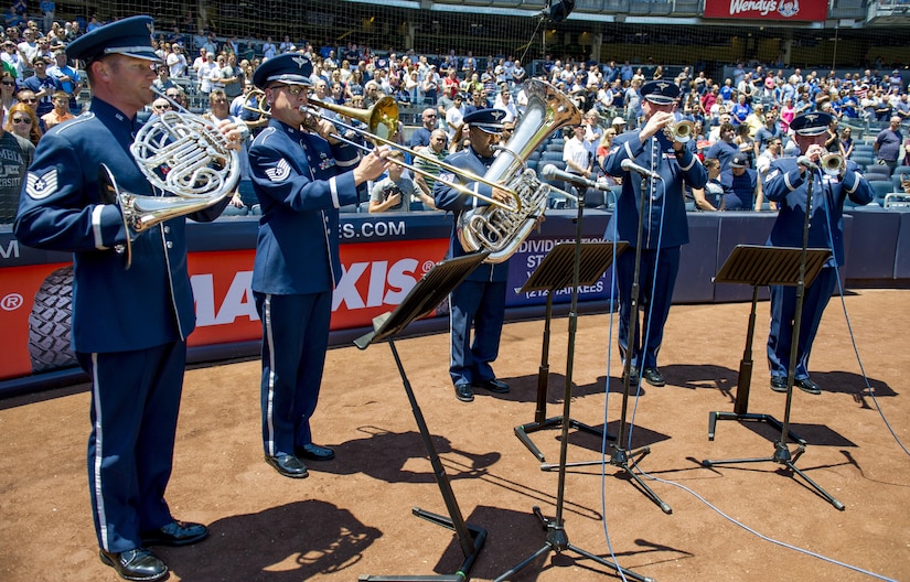 The U.S. Air Force Band ceremonial brass quintet plays the national anthem during opening ceremonies at a New York Yankees baseball game in New York City, July 4, 2017. A U.S. Air Force Honor Guard color team was also there to present colors for the national anthem. (US Air Force Photo by Airman 1st Class Gabrielle Spalding)