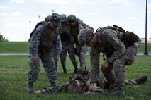 Airmen assigned to the 22nd Civil Engineer Squadron practice buddy-carry scenarios, June 26, 2017, at McConnell Air Force Base, Kan. The Airmen practiced several different carries to increase their ability to react quickly in a combat situation as part of Tactical Casualty Care training. (U.S. Air Force photo/Airman 1st Class Alan Ricker)