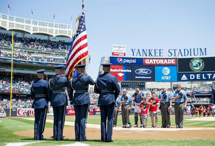 U.S. Air Force Honor Guard color team members stand at attention during the playing of the national anthem at Yankees Stadium in New York City, July 4, 2017. The U.S. Air Force Band ceremonial brass quintet and color team were there to represent the men and women of the U.S. Air Force during opening ceremonies at a Yankees baseball game. (US Air Force Photo by Airman 1st Class Gabrielle Spalding)