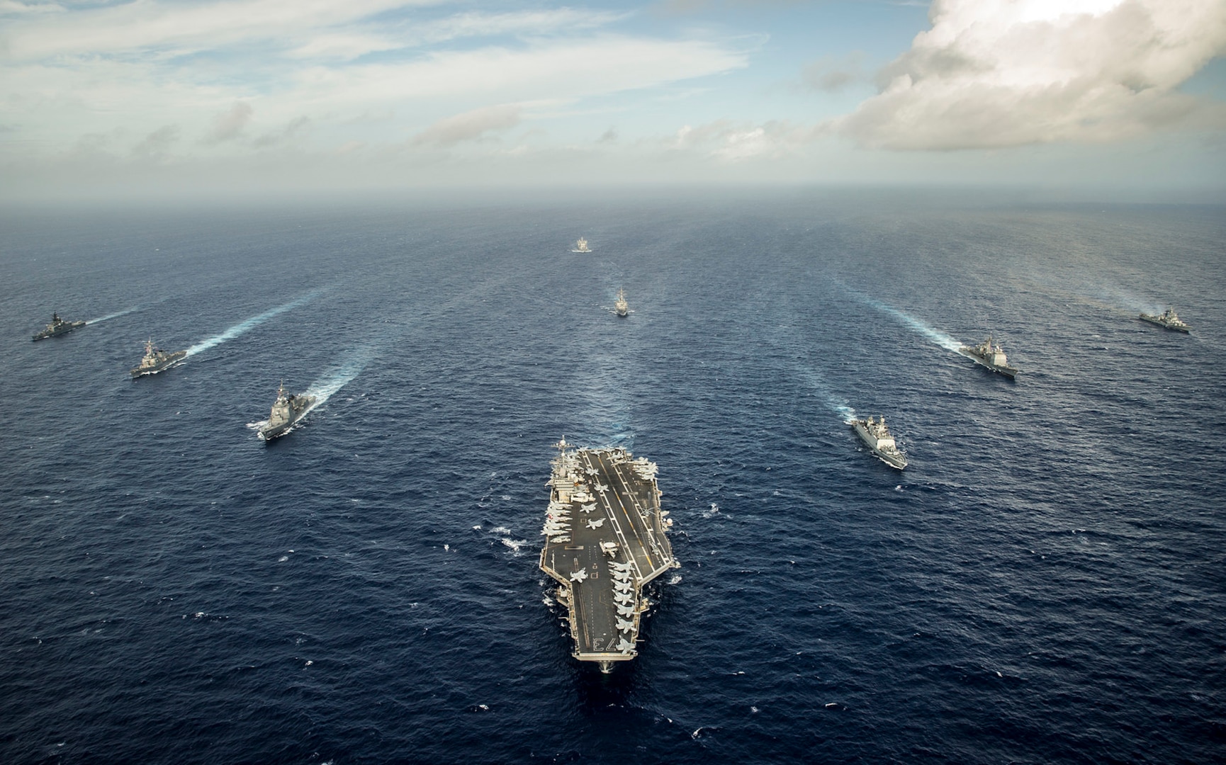 n this file photo, ships from the U.S. and Indian navies, and Japan Maritime Self-Defense Force steam in formation during Malabar 2014. 