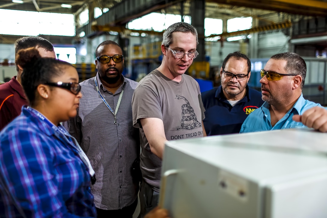 NNSY Pipe Bender Work Leader Tommy Whitaker programs coordinates into the pipe bending machine control panel.  