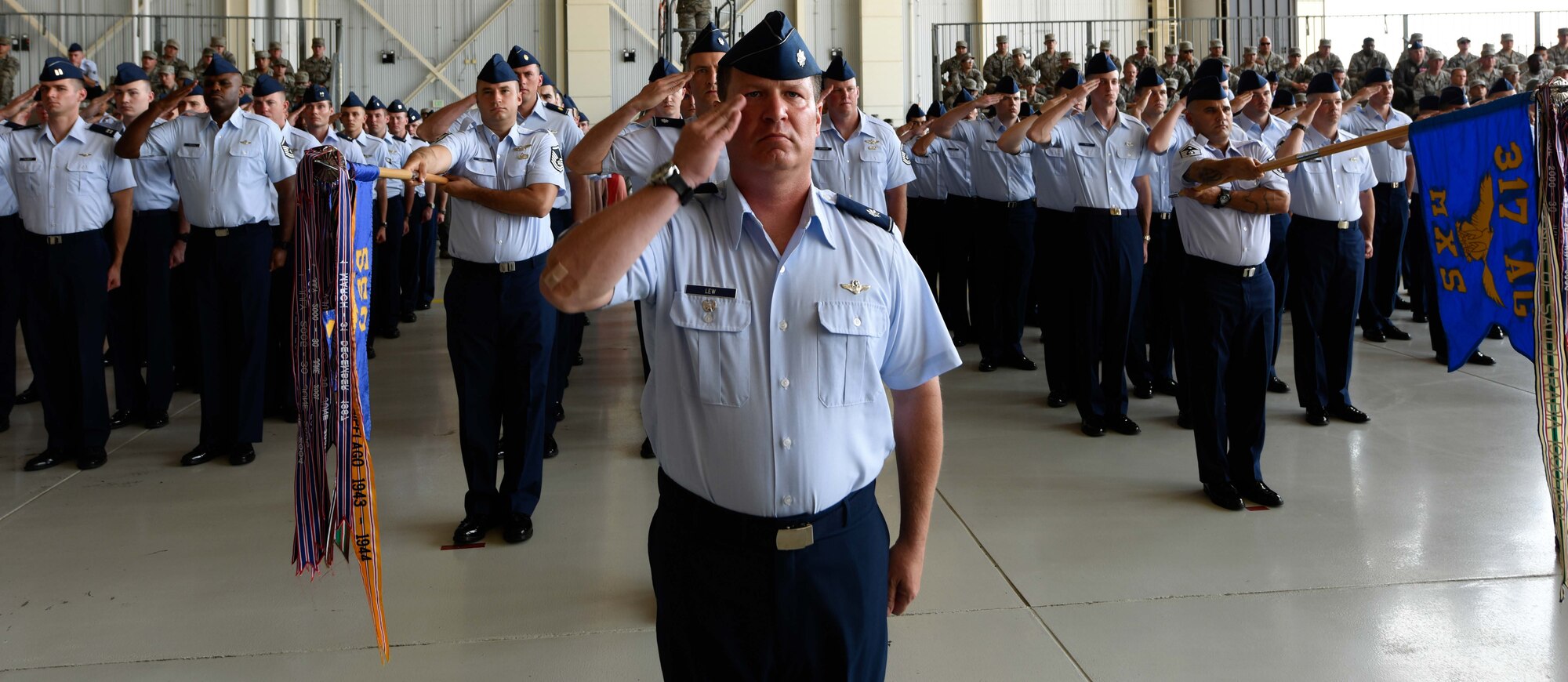 U.S. Air Force Airmen from the 317th Airlift Wing render a salute during the 317th Airlift Wing activation ceremony at Dyess Air Force Base, Texas, July 6, 2017. Under the 317th AW, the 317th Operations Group and 317th Maintenance Group were also established. (U.S. Air Force photo by Senior Airman Kedesha Pennant)