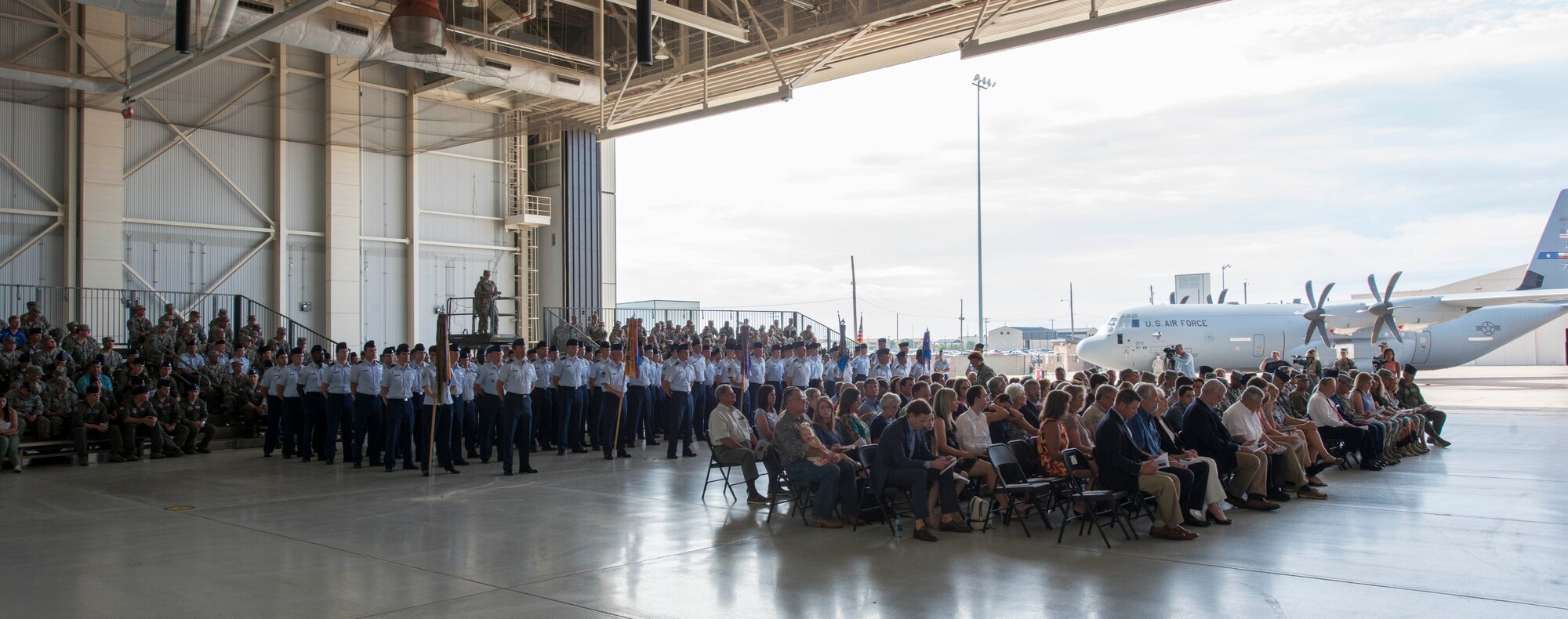 U.S. Air Force Airmen, Abilene civic leaders and family members attend the 317th Airlift Wing activation ceremony at Dyess Air Force Base, Texas, July 6, 2017. Dyess now hosts two wings in support of the bomber and airlift missions. (U.S. Air Force photo by Senior Airman Austin Mayfield)