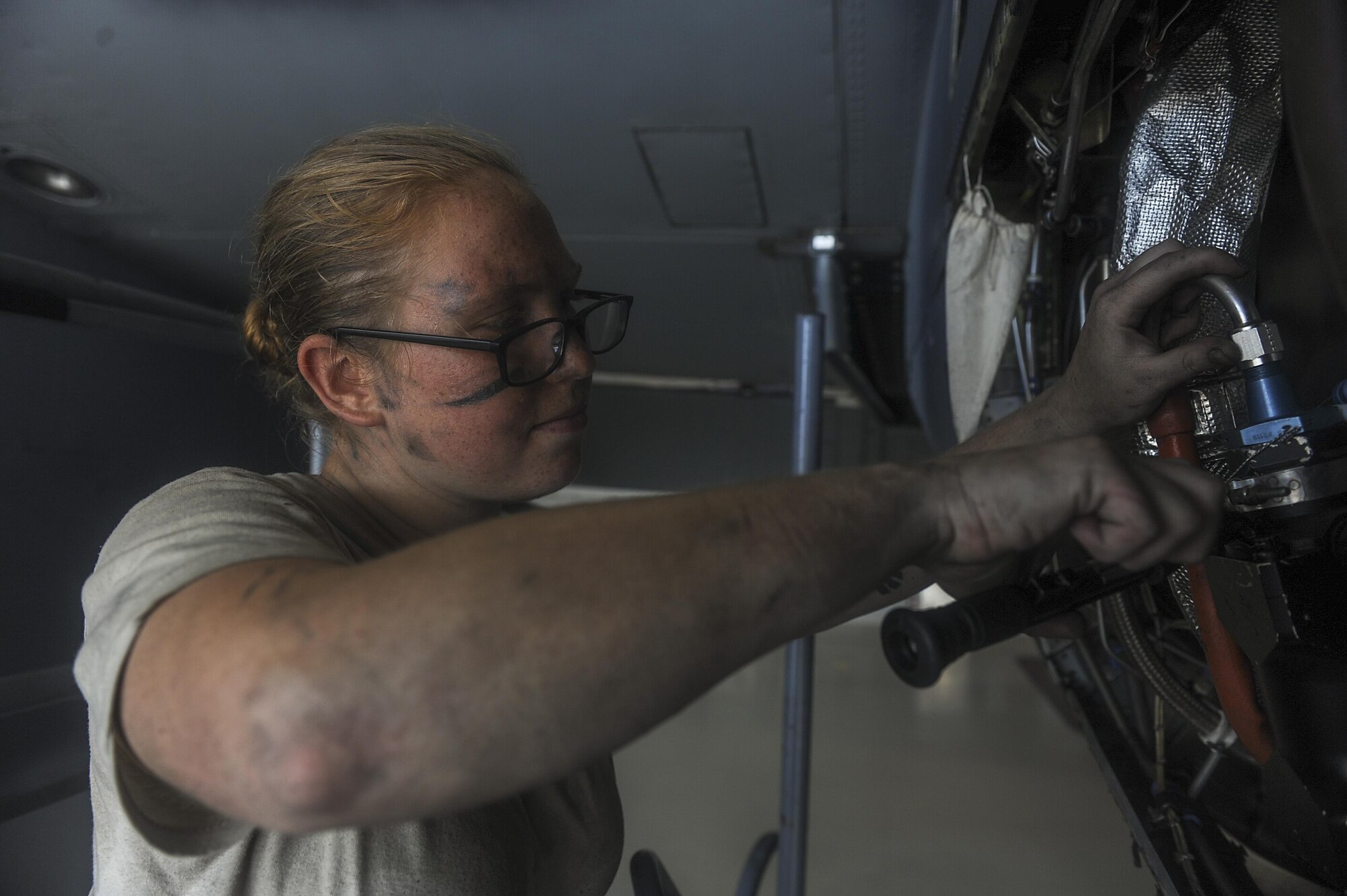 Senior Airman Maggie Jakaitis, an aerospace propulsion journeyman with the 1st Special Operations Aircraft Maintenance Squadron, safety wires a fuel nozzle on an AC-130U Spooky gunship at Hurlburt Field, Fla., July 6, 2017. Aerospace propulsion technicians test, maintain and repair AC-130U engines, preparing them to execute the mission any time, any place. (U.S. Air Force photo by Airman 1st Class Rachel Yates)