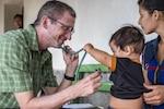 U.S. Army COL Douglas Lougee performs a physical assessment on a child during a pediatric nutritional assessment mission. Joint Task Force – Bravo Medical Element personnel participated in a pediatric nutritional assessment mission as members of a joint team with the Honduran Ministry of Health to assess the nutritional status of children from the ages of 6 months to 60 months in the San Antonio area of La Paz, Honduras, Jun 14 - 15, 2017. 
