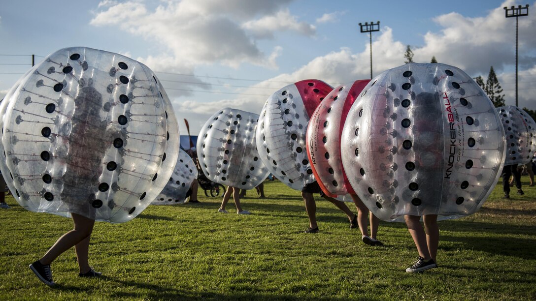 Sailors and their families play with Knockerballs or inflatable spheres during an event at Joint Base Pearl Harbor-Hickam in Pearl Harbor, Hawaii, July 4, 2017. The Moral Welfare and Recreation department hosted the event. Navy photo by Petty Officer 3rd Class Justin R. Pacheco