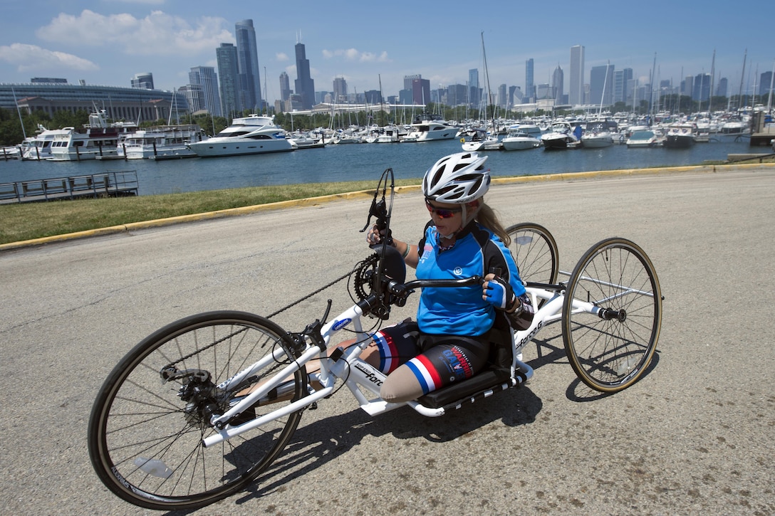 An Air Force veteran powers a handcycle during competition. 