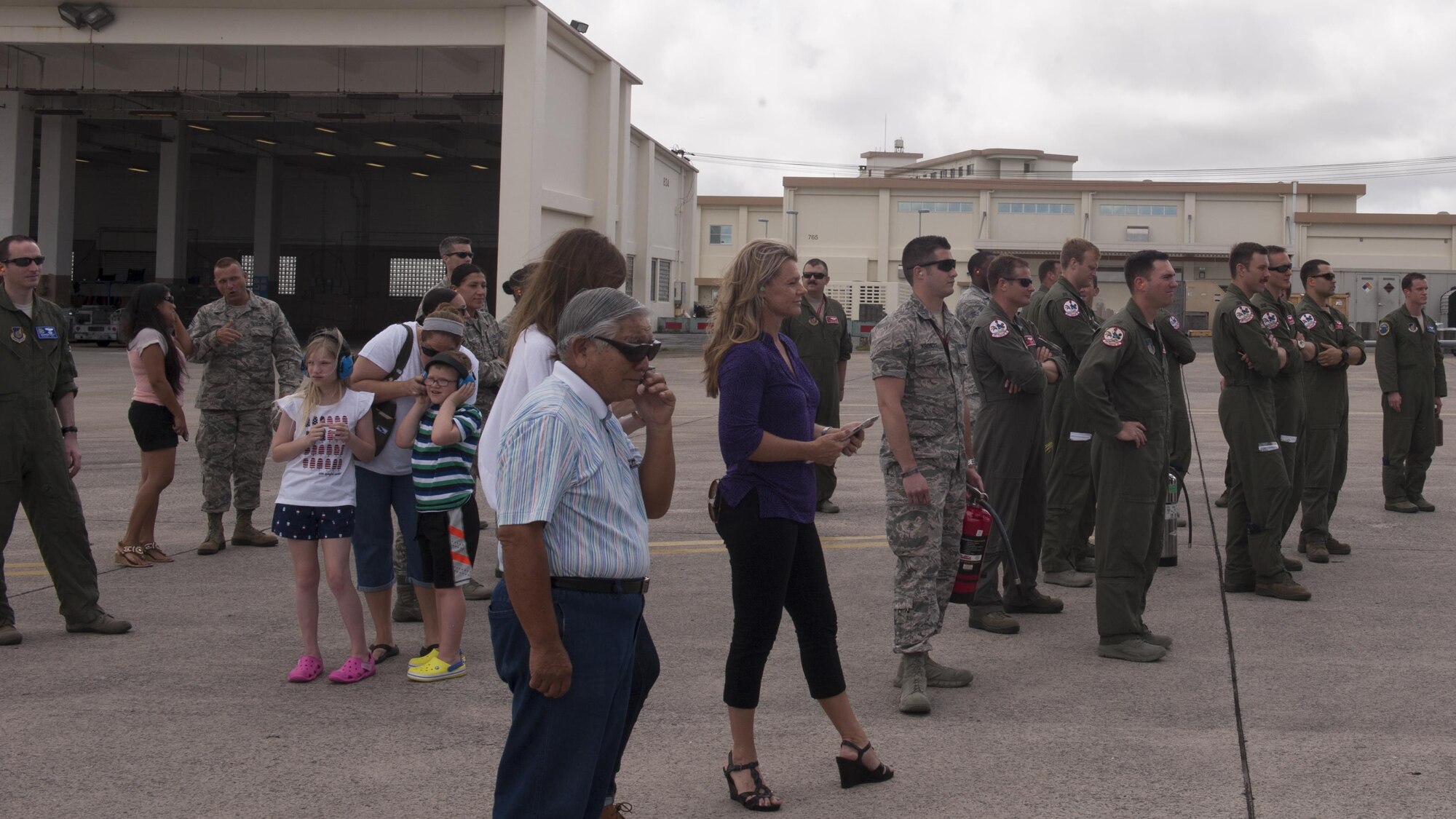 Missy Cornish, wife of U.S. Air Force Brig. Gen. Barry Cornish, 18th Wing commander, and members from Team Kadena await the F-15 piloted by Barry June 29, 2017, at Kadena Air Base, Japan.  Members from the wing and other distinguished visitors traditionally await the aircraft as a part of the final flight. (U.S. Air Force photo/ Airman 1st Class Greg Erwin)