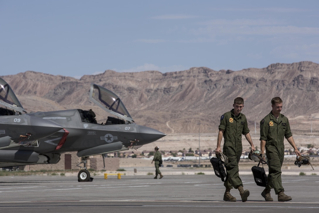 Two Marines with Marine Fighter Attack Squadron (VMFA) 211 “Wake Island Avengers,” 3rd Marine Aircraft Wing, walk away from the flight line after inspecting F-35B Lightning IIs at Nellis Air Force Base, Nev., July 5. A total of 10 aircraft and more than 250 Marines with VMFA-211 will participate in Red Flag 17-3, a realistic combat training exercise involving the U.S. Air Force and its allies, to assess the squadron’s ability to deploy and support contingency operations using the F-35B. Red Flag 17-3 begins July 10 and ends July 28. 