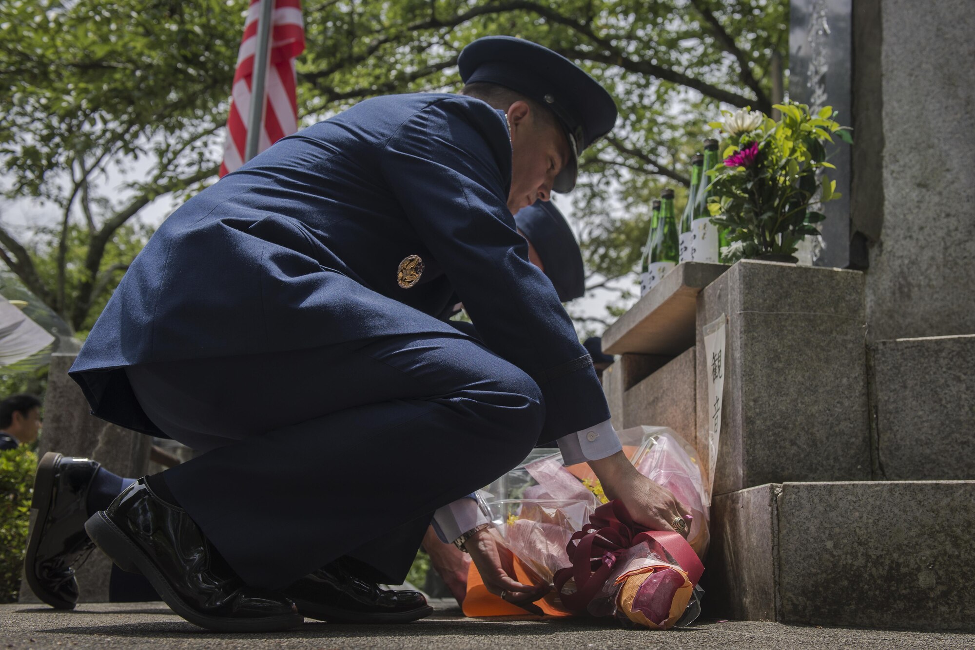 Col. Sergio J. Vega Jr., 374th Airlift Wing vice commander, places flowers on a memorial honoring thousands of Japanese civilians who died in World War II during a B-29 bombing raid, June 24, 2017, at Shizuoka City, Japan. Since 1972 Yokota Air Base Airmen have volunteered their time to take part in a US-Japan joint memorial service to pay respect to those who lost their lives on June 19, 1945, during a World War II air raid over Shizuoka. (U.S. Air Force photo by Airman 1st Class Juan Torres)