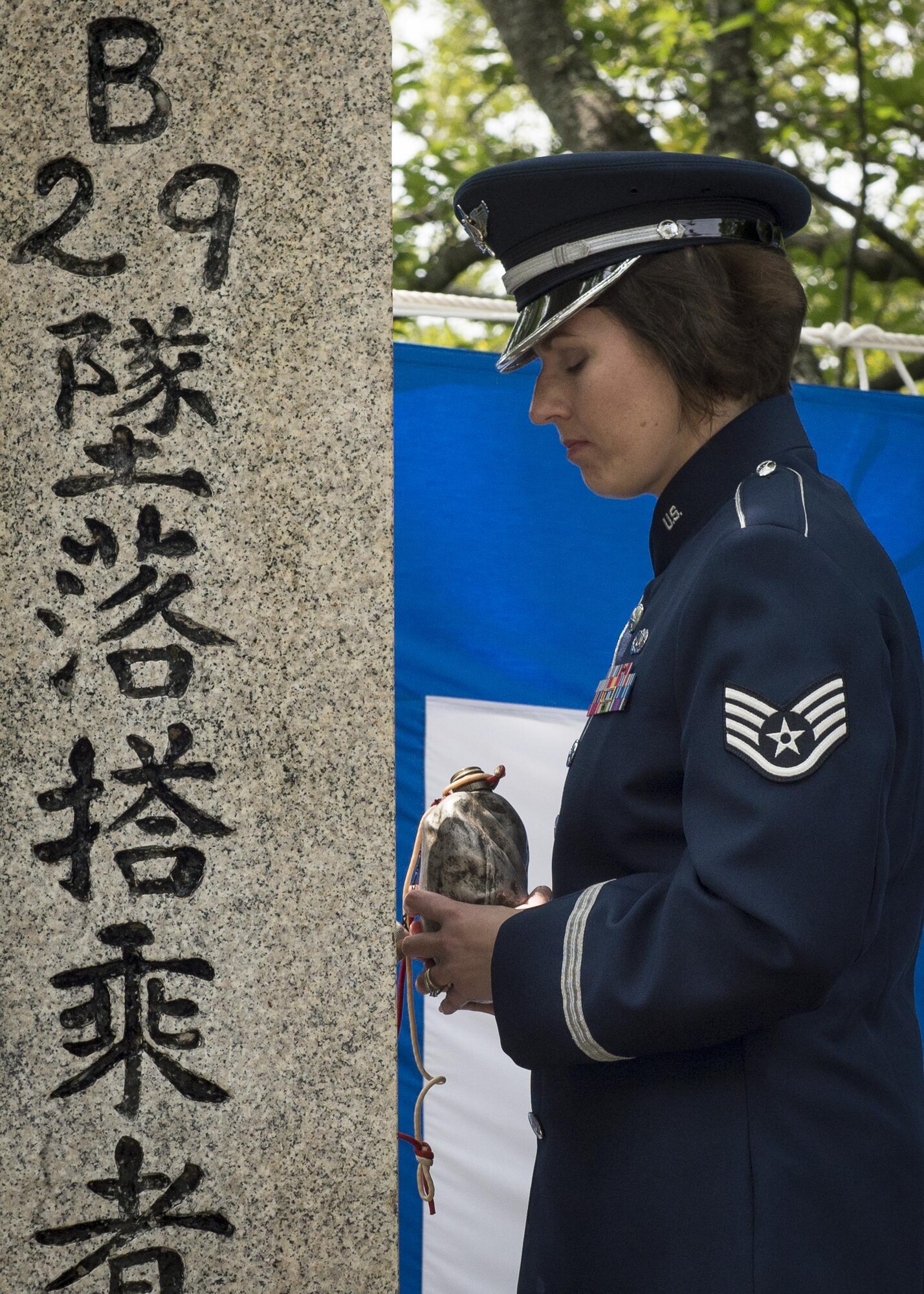 Staff Sgt. Joanne Griffin, U.S. Air Force Band of the Pacific vocalist, pauses for a moment of silence after pouring bourbon from the Blackened Canteen during a B-29 Memorial Ceremony, June 24, 2017, at Shizuoka City, Japan. Since 1972, Yokota Air Base Airmen have volunteered their time to take part in a US-Japan joint memorial service to pay respect to those who lost their lives on June 19, 1945, during a World War II air raid over Shizuoka. (U.S. Air Force photo by Airman 1st Class Juan Torres)