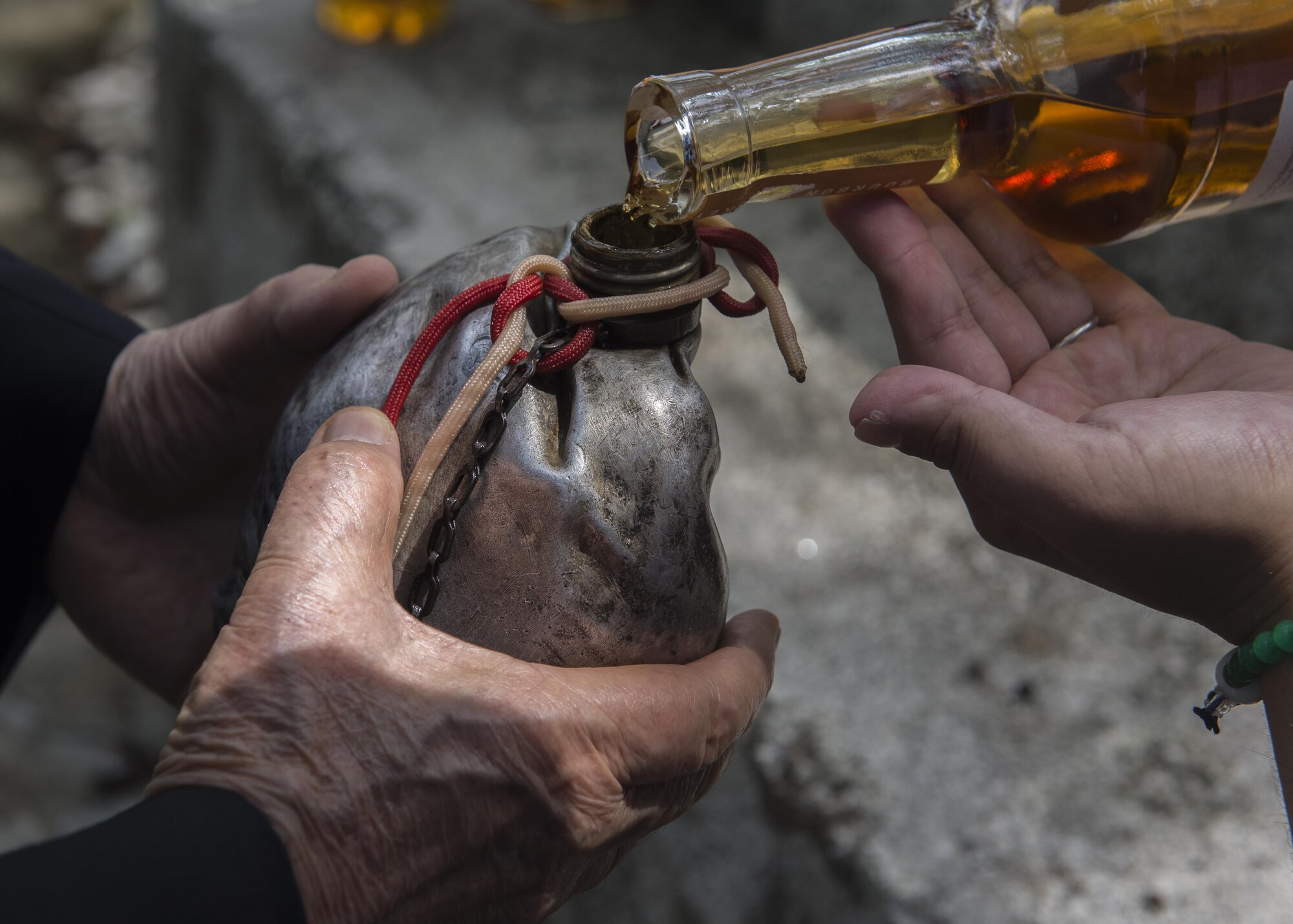 The Blackened Canteen is filled with bourbon during a B-29 Memorial Ceremony at the top of Sengen hill, June 24, 2017, at Shizuoka City, Japan. The bourbon from the canteen is offered to the American B-29 aircrew memorial. (U.S. Air Force photo by Airman 1st Class Juan Torres)