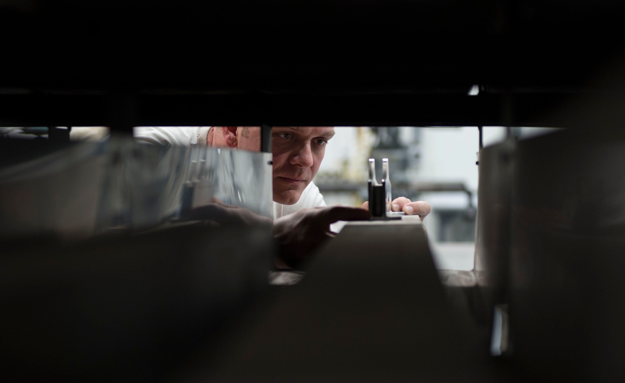 U.S. Air Force Staff Andrew Walker, a fabrication specialist with the 379th Expeditionary Maintenance Squadron compares raw material for a new project at Al Udeid Air Base, Qatar, June 5, 2017. Walker is part of a team of machinists and welders which are trained on a wide range of manual and computer numerical controlled machines to manufacture and repair aircraft components and support equipment. (U.S. Air Force photo by Tech. Sgt. Amy M. Lovgren)