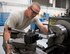 U.S. Air Force Staff Andrew Walker, a fabrication specialist with the 379th Expeditionary Maintenance Squadron uses a manual lathe to create a cylindrical part at Al Udeid Air Base, Qatar, June 5, 2017. Walker is part of a team of machinists and welders which are trained on a wide range of manual and computer numerical controlled machines to manufacture and repair aircraft components and support equipment. (U.S. Air Force photo by Tech. Sgt. Amy M. Lovgren)